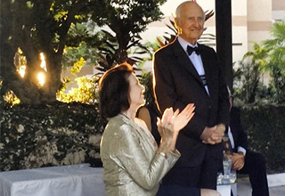 Woman clapping hands together while announcing something